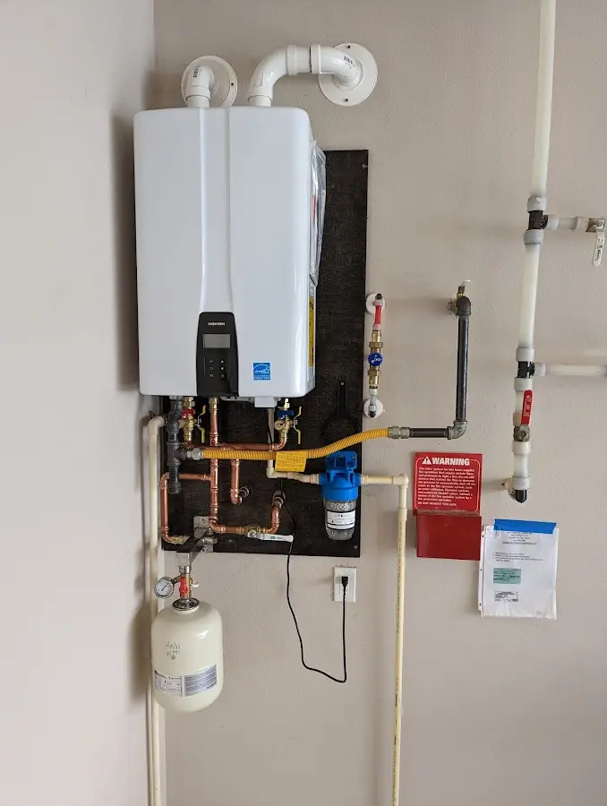 Professional plumber installing copper piping in a East Rockaway home